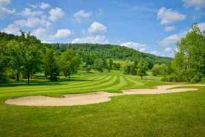 Green golf course with sand trap