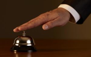 A hand about to ring a service bell